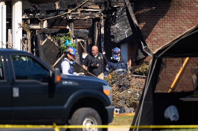 Investigators at The Church of Jesus Christ of Latter-day Saints in Grand Blanc Township, Mich., on Sept. 30, 2025.