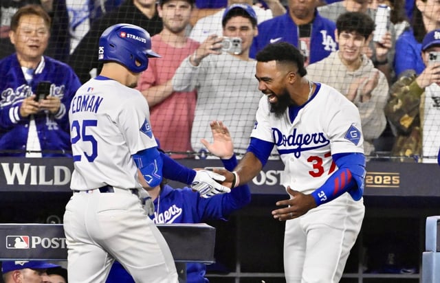 The Dodgers’ Tommy Edman, left, celebrates with teammate Teoscar Hernández as he returns to the dugout after hitting a solo home run during the third inning of Game 1 of their National League Wild Card Series against the Cincinnati Reds on Tuesday, Sept. 30, 2025, at Dodger Stadium. Hernandez hit two homers in the 10-5 win. (Photo by Keith Birmingham, Pasadena Star-News/SCNG)
