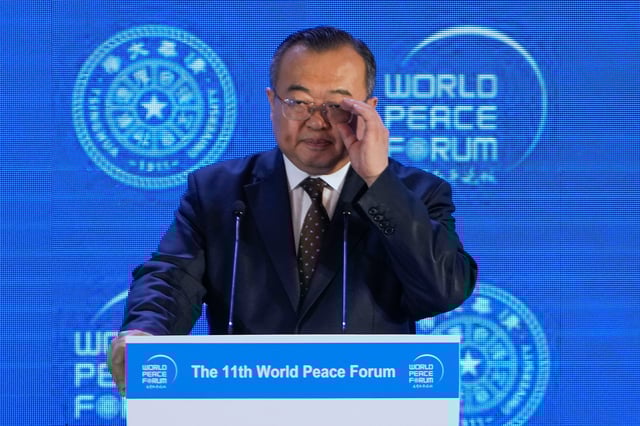 FILE - Liu Jianchao, Minister of the International Department of the Chinese Communist Party Central Committee adjusts his glasses during a Q&A session for a lunch meeting of the 11th World Peace Forum at a hotel in Beijing, July 2, 2023. .(AP Photo/Andy Wong, File)