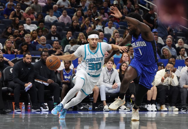 Nov 12, 2024; Orlando, Florida, USA; Charlotte Hornets guard Seth Curry (30) drives to the basket as Orlando Magic forward Jonathan Isaac (1) defends during the first quarter at Kia Center. Mandatory Credit: Kim Klement Neitzel-Imagn Images