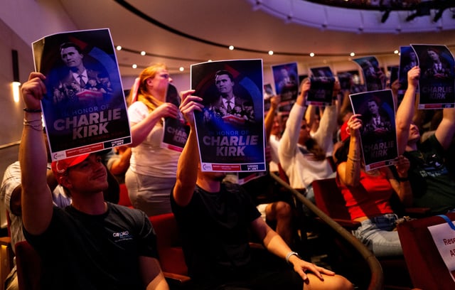 Attendees hold up posters of Charlie Kirk — like those seen in Utah — during the "American Comeback Tour" event at Northrop Auditorium on the University of Minnesota campus on September 22, 2025 in Minneapolis, Minnesota.