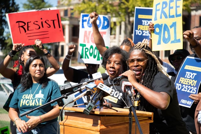 Rachael Spriggs, accompanied by Sandra Pita, left, and Tikeila Rucker, center, addresses protesters gathered for a march in Memphis on Saturday to protest against the deployment of National Guard troops to the city.