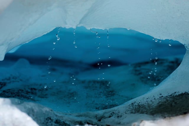 FILE - Water drips from a melting chunk of ice that originated from the Rhone Glacier near Goms, Switzerland, on June 10, 2025. (AP Photo/Matthias Schrader, File)