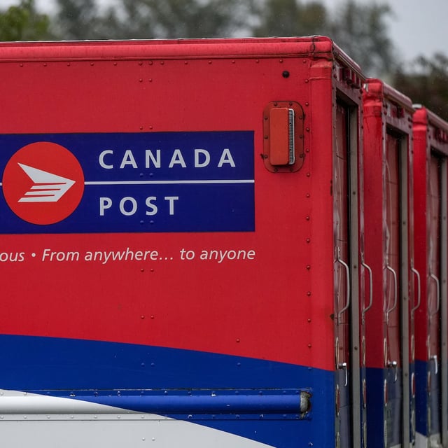 Vehicles sit idle at a Canada Post delivery depot, in Burnaby, B.C., on Monday, September 29, 2025. The Canadian Union of Postal Workers took to the picket lines Thursday after Ottawa announced sweeping changes to the Crown corporation's operations to address its troubled financial situation. THE CANADIAN PRESS/Darryl Dyck