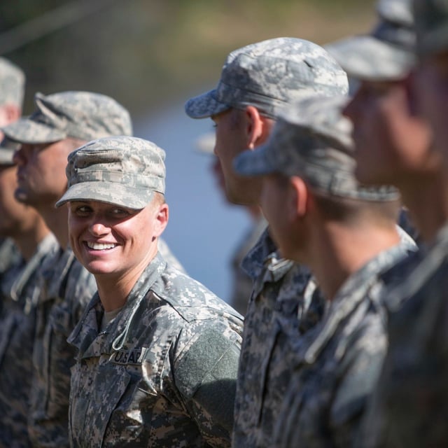 FILE - Maj. Lisa Jaster, center, the first Army Reserve female to graduate the Army's Ranger School, stands in formation with other Rangers during an Army Ranger school graduation ceremony, Oct. 16, 2015, in Fort Benning, Ga. (AP Photo/Branden Camp, File)