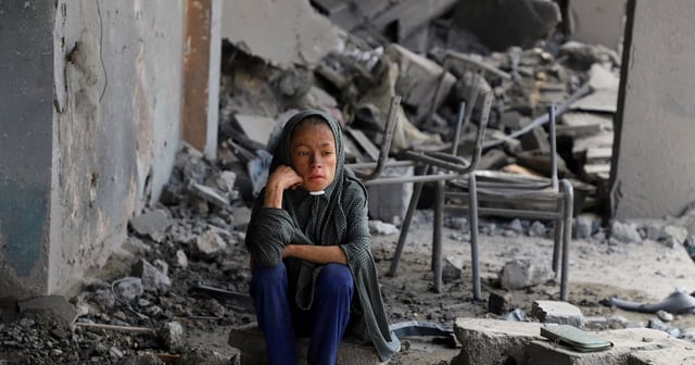 A Palestinian sits amid the debris of a UN school hit in overnight Israeli strikes in Gaza city. Reuters