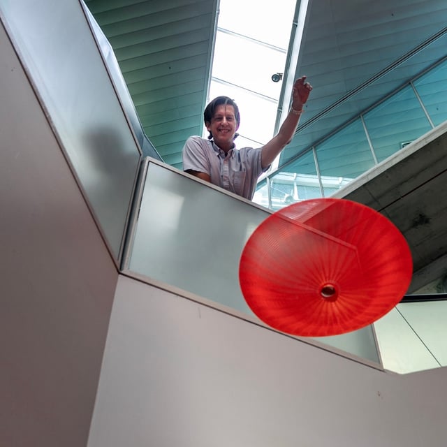 Frederick Gosselin demonstrates a new type of parachute designed by a team at the École Polytechnique. The parachute was dropped into the atrium of the Polytechnique carrying eggs and on it's own.