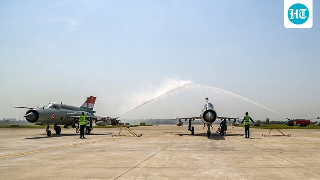Indian Air Force MiG-21 aircraft receive water salute during the decommissioning ceremony at the Chandigarh air force station.
