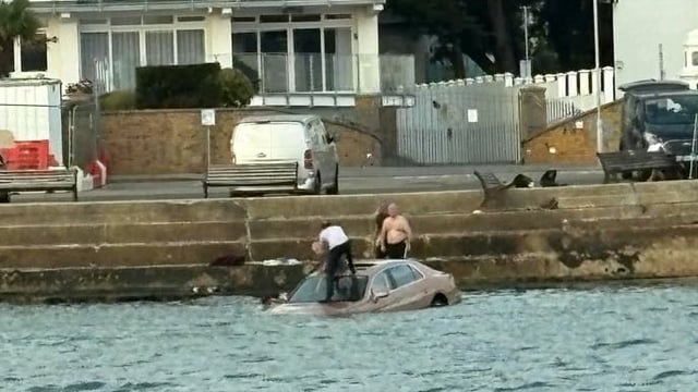 Anglers climbed on to the bonnet of the Bentley to rescue Robert Hill at Sandbanks harbour