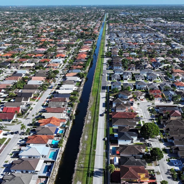 MIAMI, FLORIDA - AUGUST 01: An aerial view of single family homes on August 01, 2025 in Miami, Florida. Home sales have fallen across South Florida as high interest rates and other factors have weighed on the market. (Photo by Joe Raedle/Getty Images)