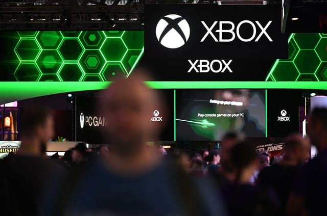 Visitors walk past the Xbox booth at the Gamescom video games trade fair in Cologne, western Germany on August 22, 2024. According to organisers, around 1400 exhibitors from 64 countries will be presenting their products during the fair running until August 25, 2024. (Photo by Ina FASSBENDER / AFP) (Photo by INA FASSBENDER/AFP via Getty Images)