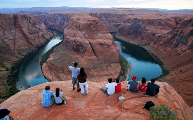 File photo: visitors view the dramatic bend in the Colorado River at the popular Horseshoe Bend in Glen Canyon National Recreation Area, in Page, Arizona.