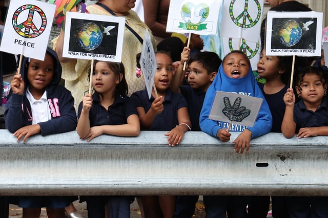 Kindergarteners at Arther Libby Elementary school hold signs during a Peace Walk Out for International Day of Peace in Chicago’s Back of the Yards neighborhood on Sept. 23, 2025. More children in Illinois overall are demonstrating readiness for kindergarten compared with previous years. (Antonio Perez/Chicago Tribune)