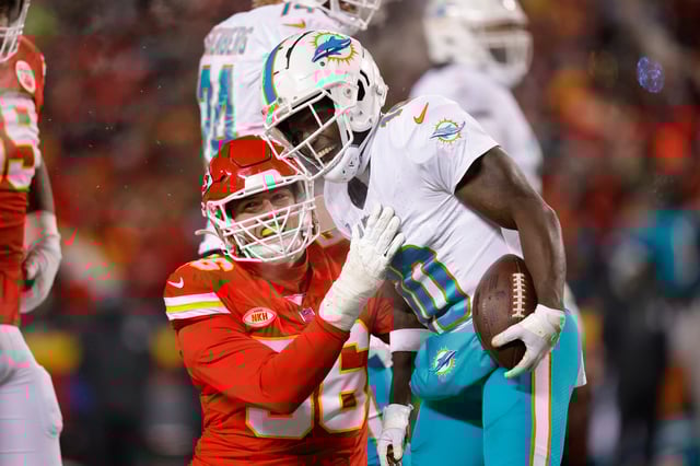 KANSAS CITY, MISSOURI - JANUARY 13: George Karlaftis #56 of the Kansas City Chiefs and Tyreek Hill #10 of the Miami Dolphins react after a play during the second quarter in the AFC Wild Card Playoffs at GEHA Field at Arrowhead Stadium on January 13, 2024 in Kansas City, Missouri. (Photo by David Eulitt/Getty Images)