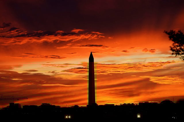 The sun sets behind the Washington Monument in Washington, DC, on the day of a Senate vote, hours before a partial government shutdown is set to take effect after midnight Sept. 30, 2025.