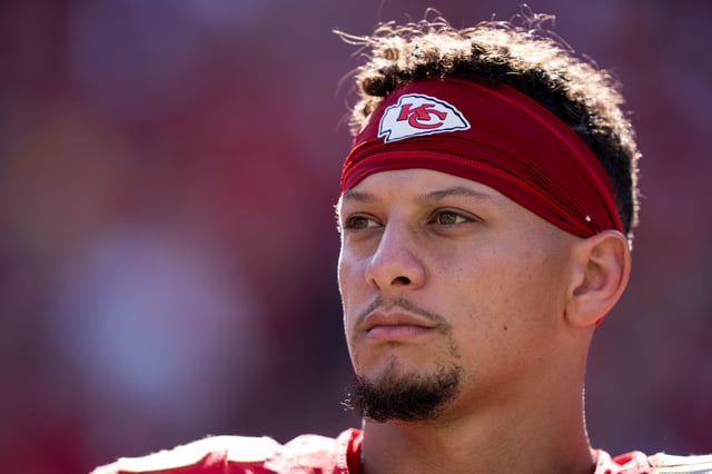 KANSAS CITY, MISSOURI - SEPTEMBER 28: Patrick Mahomes #15 of the Kansas City Chiefs looks on during the national anthem prior to an NFL football game against the Baltimore Ravens at GEHA Field at Arrowhead Stadium on September 28, 2025 in Kansas City, Missouri. (Photo by Michael Owens/Getty Images)