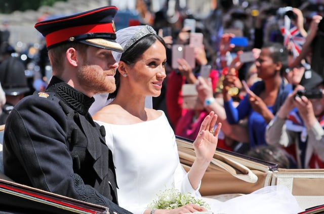 FILE – In this file photo dated Saturday, May 19, 2018, Britain’s Prince Harry and his bride Meghan Markle, ride in a carriage after their wedding ceremony at St. George’s Chapel in Windsor Castle in Windsor, near London, England.  Kensington Palace announced Monday Oct. 15, 2018, that Prince Harry and his wife the Duchess of Sussex are expecting a child in spring 2019. (AP Photo/Frank Augstein, FILE)