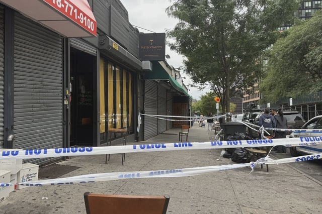 Police tape outside the Taste of the City Lounge in August.