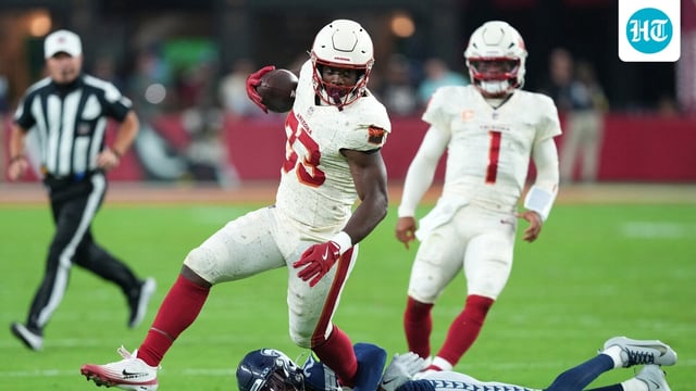 Arizona Cardinals running back Trey Benson (33) runs against Seattle Seahawks cornerback Devon Witherspoon (21)