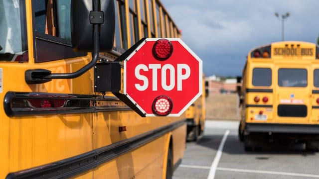 A stop sign on a school bus.