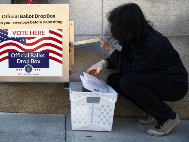 PORTLAND, ME - NOVEMBER 3: Chris Horne, a staffer with the Portland City Clerk's Office, unloads absentee ballots from a drop box at City Hall on Tuesday morning. Horne said she had unloaded the box three times by 10:30 a.m. and usage has been heavy, particularly overnight. (Staff photo by Ben McCanna/Portland Press Herald via Getty Images)