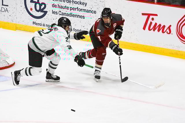 Jan 13, 2024; Montreal, Quebec, CANADA; Montreal forward Laura Stacey (7) plays the puck against Boston defender Jessica Digirolamo (22) during the third period in a PWHL ice hockey game at Verdun Auditorium. Mandatory Credit: David Kirouac-USA TODAY Sports/ File Photo