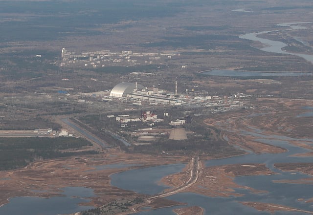 An aerial view from a plane shows a New Safe Confinement (NSC) structure over the old sarcophagus covering the damaged fourth reactor at the Chernobyl Nuclear Power Plant during a tour to the Chernobyl exclusion zone, Ukraine April 3, 2021. REUTERS/Gleb Garanich/File Photo