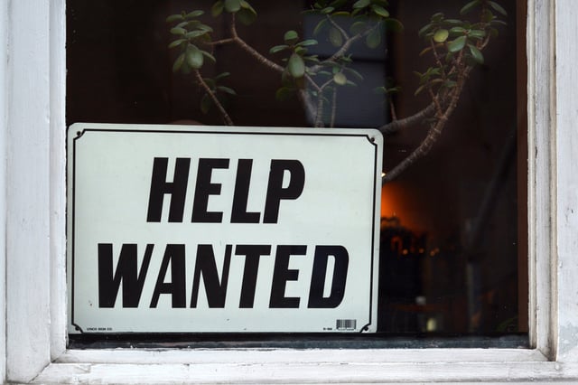 A "Help Wanted" sign is in a shop window in San Francisco, California on September 12, 2018.