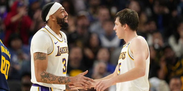 Lakers forward Anthony Davis (3) celebrates with guard Austin Reaves (right) during the fourth quarter against the Golden State Warriors at Chase Center