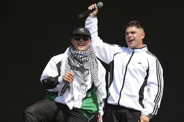 Liam Og, left, and Naoise O Caireallain of the hip hop trio Kneecap perform during the Glastonbury Festival in Worthy Farm, Somerset, England, Saturday, June 28, 2025. (Scott A Garfitt/Invision/AP)