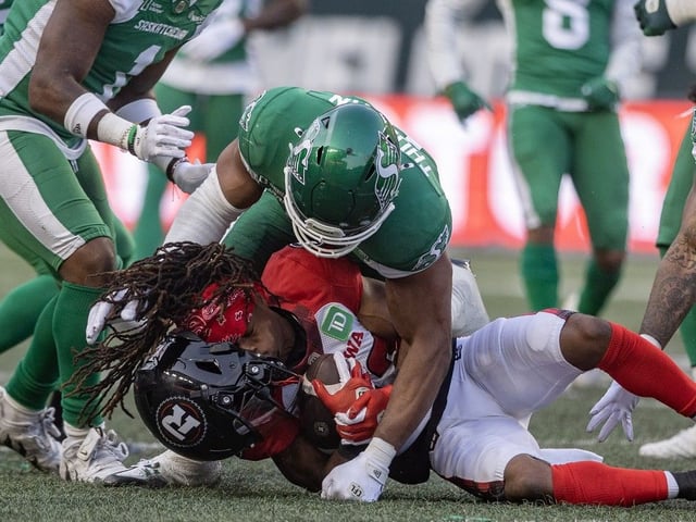 Ottawa Redblacks receiver Kalil Pimpleton (83) has his helmet knocked off after a tackle by the Saskatchewan Roughriders during the first half of CFL action as the Saskatchewan Roughriders play the Ottawa Redblacks for the home opener at Mosaic Stadium on Thursday, June 5, 2025 in Regina.