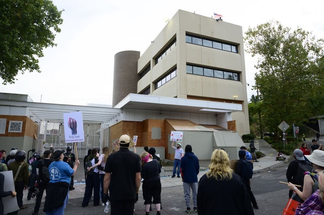 Federal agents observe the crowd of protesters outside of the US Immigration and Customs Enforcement building on September 28, in Portland, Oregon.
