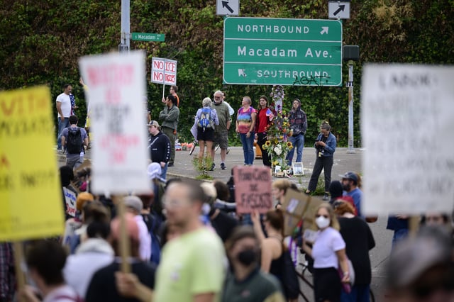 Protesters stand outside of the US Immigration and Customs Enforcement building on September 28, 2025 in Portland, Oregon.