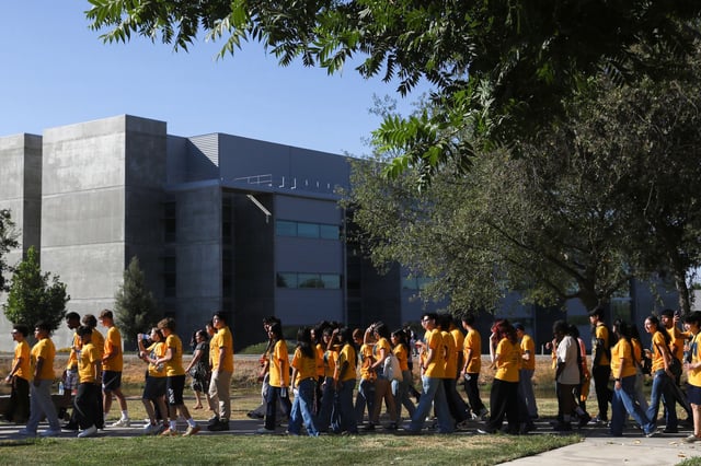 UC Merced freshmen walk through the New Beginnings Statue to mark their arrival on campus in August 2024. The new Wall Street Journal/College Pulse ranking, released Monday, put UC Merced at No. 14 in the nation.