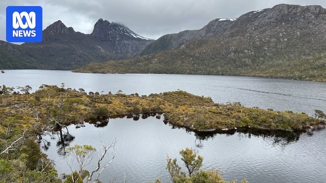 A mountain next to a lake