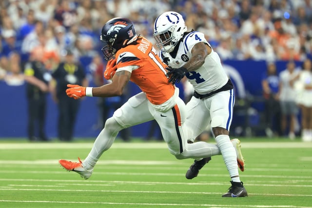 INDIANAPOLIS, INDIANA - SEPTEMBER 14:  Pat Bryant #13 of the Denver Broncos is is pursued by Xavien Howard #4 of the Indianapolis Colts during the first half at Lucas Oil Stadium on September 14, 2025 in Indianapolis, Indiana. (Photo by Justin Casterline/Getty Images)