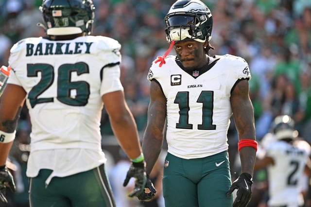 Eagles wide receiver AJ. Brown (11) and running back Saquon Barkley (26) during the fourth quarter against the Los Angeles Rams at Lincoln Financial Field. Mandatory Credit: Eric Hartline-Imagn Images
