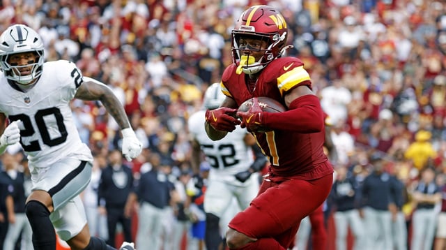 Sep 21, 2025; Landover, Maryland, USA; Washington Commanders wide receiver Terry McLaurin (17) runs the ball during the second half as Las Vegas Raiders safety Isaiah Pola-Mao (20) defends at Northwest Stadium. Mandatory Credit: Amber Searls-Imagn Images