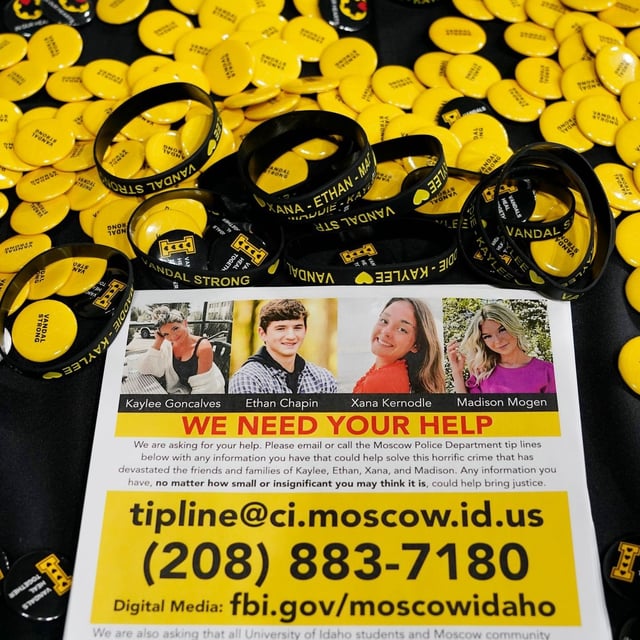 FILE - A flyer seeking information about the killings of four University of Idaho students who were found dead is displayed on a table along with buttons and bracelets on Nov. 30, 2022, during a vigil in memory of the victims in Moscow, Idaho. (AP Photo/Ted S. Warren, File)
