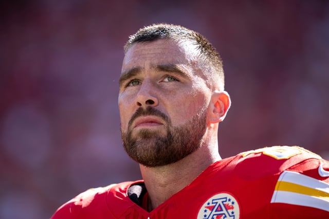 Travis Kelce #87 of the Kansas City Chiefs looks on during the national anthem prior to an NFL football game against the Baltimore Ravens at GEHA Field at Arrowhead Stadium on September 28, 2025 in Kansas City, Missouri. (Photo by Michael Owens/Getty Images)
