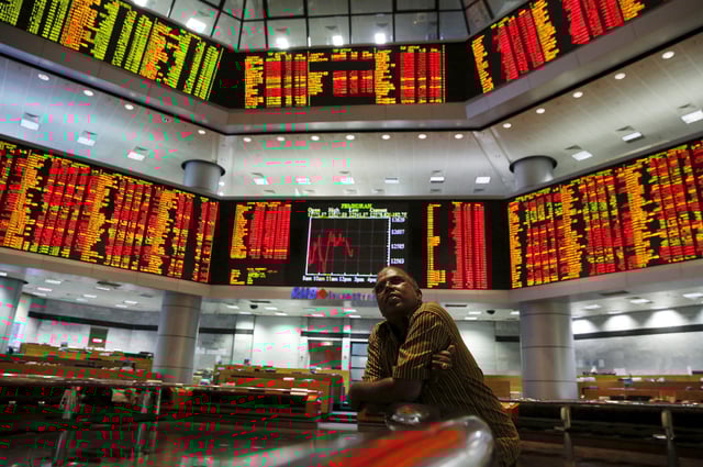 An investor monitors share market prices at a brokerage firm in Kuala Lumpur, Malaysia, August 24, 2015. REUTERS/Olivia Harris/File Photo