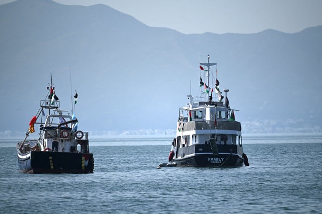 A ship, from right, known as the "Family" and is part of the Global Sumud Flotilla, is anchored off the coast of the village of Sidi Bou Said, on Sept. 9, 2025.