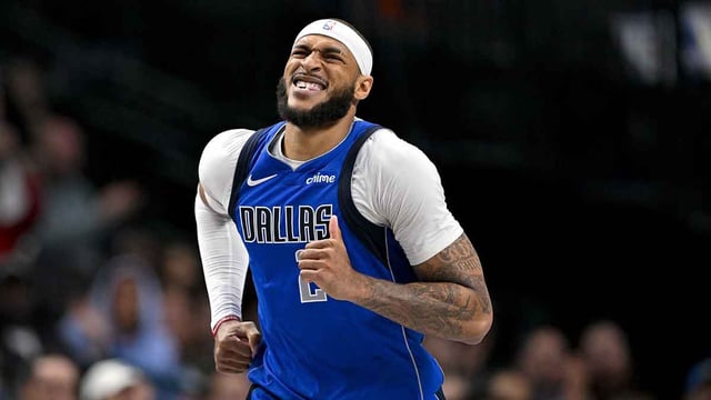 Mar 31, 2025; Dallas, Texas, USA; Dallas Mavericks center Daniel Gafford (21) grimaces as he runs back up the court during the second half against the Brooklyn Nets at the American Airlines Center. Mandatory Credit: Jerome Miron-Imagn Images
