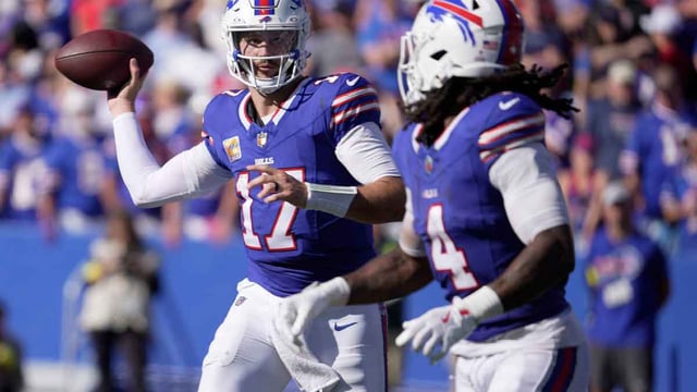 Buffalo Bills quarterback Josh Allen looks at running back James Cook as he launches a short pass to him during second half action of the Bills home game against the New Orleans Saints in Orchard Park on Sept. 28, 2025.