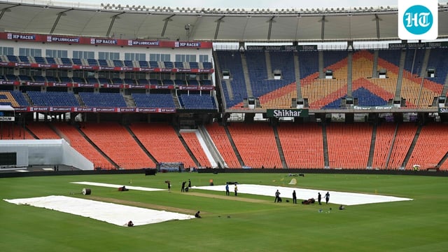 Groundsmen work at the Narendra Modi Stadium in Ahmedabad.