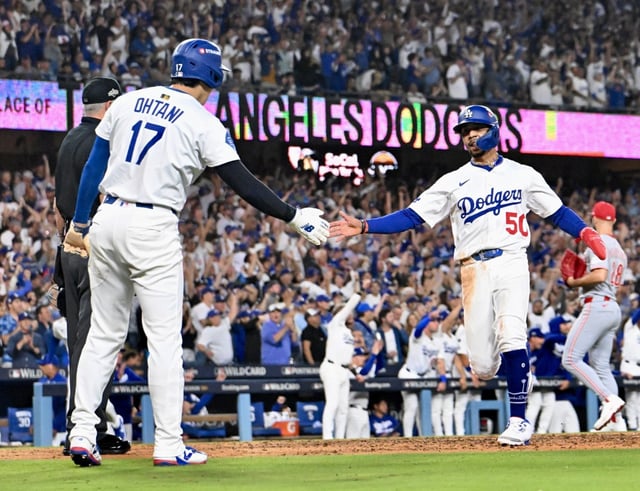 Dodgers star Mookie Betts, right, is congratulated by teammate Shohei Ohtani after scoring a run during the sixth inning of Game 2 of their National League Wild Card Series against the Cincinnati Reds on Wednesday, Oct. 1, 2025, at Dodger Stadium. (Photo by Keith Birmingham, Pasadena Star-News/SCNG)