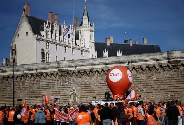 Protesters wearing CFDT labour union vests stand next to a CFDT balloon during a demonstration in Nantes as part of a day of nationwide strikes and protests against the government and possible austerity cuts, France, October 2, 2025.REUTERS/Stephane Mahe
