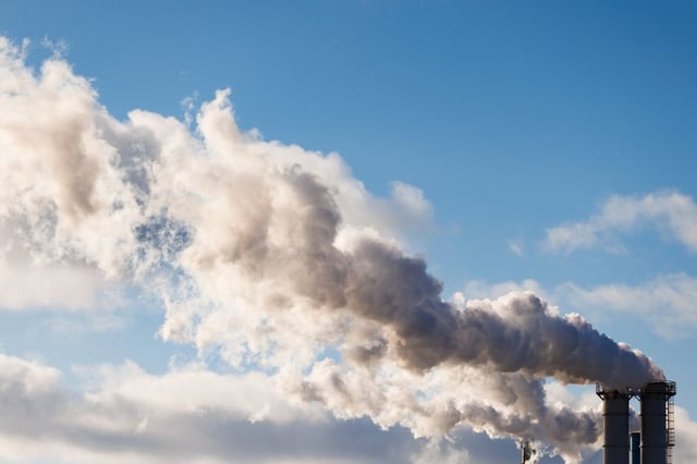 Emissions flow from a factory's smokestacks on a cold winter day in Toronto, Wednesday, Jan. 8, 2025. 