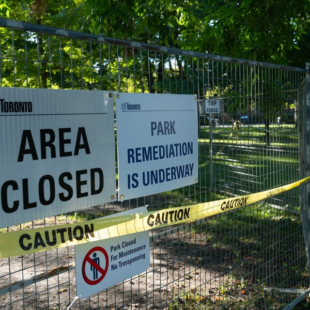 Security guards watch over Dufferin Grove Park in Toronto, on Wednesday.
