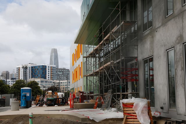 Downtown San Francisco is visible in the background Tuesday as construction of the Mission Bay School, expected to open in August, continued.